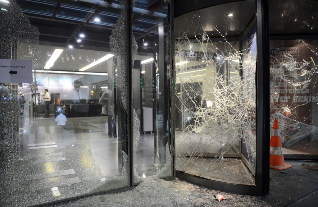 This photo taken on September 8, 2015 shows broken windows of the headquarters of the Hurriyet newspaper on September 8, 2015, in Istanbul's Bagcilar district, after an attack. Supporters of Turkey's ruling Justice and Development Party (AKP) stormed the headquarters of the Hurriyet newspaper today in Istanbul after accusing the daily of misquoting President Recep Tayyip Erdogan. The attack on the newspaper comes amid growing concern over press freedoms in Turkey and the use of the courts by the president to pursue journalists who criticise him. AFP PHOTO / HURRIYET DAILY (Photo credit should read -/AFP/Getty Images)
